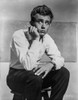 James Dean Seated on a Chair in White Long Sleeve Collar Shirt and Black Linen Pants with Knees Bent and Head Leaning on the Hand Photo Print - Item # VARCEL694146
