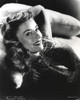 Paulette Goddard smiling while Lying on Couch in Glitter Dress Portrait Photo Print - Item # VARCEL694619