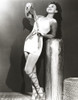 Paulette Goddard Leaning on Post and Looking Up wearing Sexy White Dress Photo Print - Item # VARCEL694775
