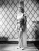 Hillary Brooks Leaning on Post in Printed Dress Photo Print - Item # VARCEL694899