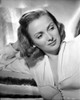 Jean Brooks Posed in White Deep V-Neck Long Sleeve Dress with Head Leaning on the Right Hand Photo Print - Item # VARCEL694993