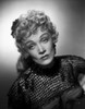 Marlene Dietrich sitting in Elegant Dress with Black Net Sleeves Photo Print - Item # VARCEL695257