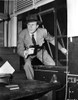 A Publicity Still Of Lawrence Tierney Climbing through A Window Photo Print - Item # VARCEL695610