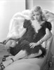 Gloria Grahame Posed on Couch wearing a Black Dress Photo Print - Item # VARCEL695624