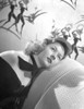 Gloria Grahame Curly Hair Lying on Couch in Black Gown with Tie Photo Print - Item # VARCEL695729