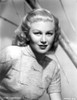 Joan Caulfield sitting and Looking at the Camera in a Classic Portrait Photo Print - Item # VARCEL695968