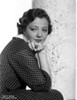 Sylvia Sidney sitting and Leaning Face on Hand in Printed Dress Photo Print - Item # VARCEL704507