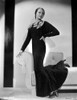 Sylvia Sidney posed on a White Couch in a Black Long Gown Photo Print - Item # VARCEL704564