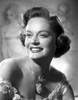 Alexis Smith smiling and wearing a Necklace with Big Pendant Photo Print - Item # VARCEL704764