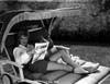 Claire Trevor Reclining on Couch, wearing White Long Sleeve with Magazine Photo Print - Item # VARCEL705213