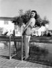 Jane Withers Posed in Gingham One Piece Swimsuit and Leaning Back while Hands Holding on the Metal Handle Photo Print - Item # VARCEL705611