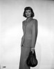 Jane Wyman Posed in Grey Linen Long Sleeve Tweed Suit Dress and Long Skirt with Right Hand Holding a Black Velvet Handbag Photo Print - Item # VARCEL705843