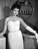 Ursula Theiss wearing a white, feathered, spaghetti strapped dress, with white gloves Photo Print - Item # VARCEL706371