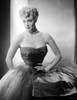 Jan Sterling Portrait in Black Velvet Dress with Sheer Silk Skirt while Hands on the Waist Photo Print