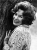 Shirley MacLaine Leaning and smiling on Tree Photo Print - Item # VARCEL706632