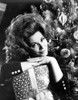 Irina Demick Leaning on Gift with Christmas Tree Photo Print - Item # VARCEL706936