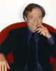 George Segal smiling While Siting on Red Couch in Black Suit and Necktie Photo Print - Item # VARCEL706994