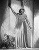 Barbara Stanwyck standing in Elegant Long Dress Classic Portrait Photo Print - Item # VARCEL707597