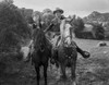A film still featuring Bob Steele and a woman riding horses Photo Print - Item # VARCEL707681