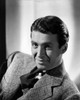James Stewart Posed in Black Velvet Necktie and White Cotton Shirt with Grey Linen Coat while Leaning to the Left Photo Print - Item # VARCEL707887