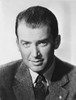 James Stewart Portrait in Grey Linen Sport Coat and Black Printed Silk Necktie while Staring Straight in White Background Photo Print - Item # VARCEL707938