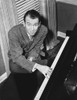 James Stewart Posed in Grey Sport Coat while Seated on the Chair and Playing Piano Photo Print - Item # VARCEL707952