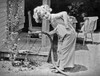 Shirley Temple Posed in Jumper suit watering flowers Photo Print - Item # VARCEL708438