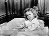 Shirley Temple sitting on the Bed in a Portrait Photo Print - Item # VARCEL708500