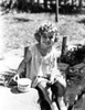 Shirley Temple sitting on the River Bank in aClassic Portrait Photo Print - Item # VARCEL708526