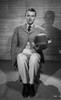 John Wayne sitting on a Chair and Holding His Hat Photo Print - Item # VARCEL709220