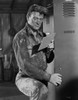 John Wayne reading paper in a hat Photo Print - Item # VARCEL709230