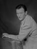 John Wayne Leaning on a Foam, wearing a Suit Photo Print - Item # VARCEL709235
