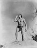 Johnny Weissmuller Shouting on Top of a Big Rock in a Movie Scene Photo Print - Item # VARCEL709314