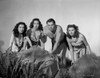 Johnny Weissmuller Kneeling on the Ground with Three Woman in a Classic Movie Scene Photo Print - Item # VARCEL709327