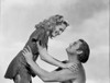Johnny Weissmuller Lifting a Lady with His Two Hands in a Movie Scene Photo Print - Item # VARCEL709344