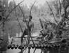 Johnny Weissmuller Riding a Raft with His Friends in a Classic Movie Scene Photo Print - Item # VARCEL709417