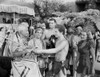 Johnny Weissmuller Giving a Present to an Old Man in a Classic Movie Scene Photo Print - Item # VARCEL709419