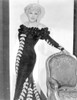 Mae West Leaning on Chair, wearing Black Dress with Curly Hairstyle Photo Print - Item # VARCEL709660