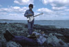 John Lennon and George Harrison at a beach Photo Print - Item # VARGLP348605