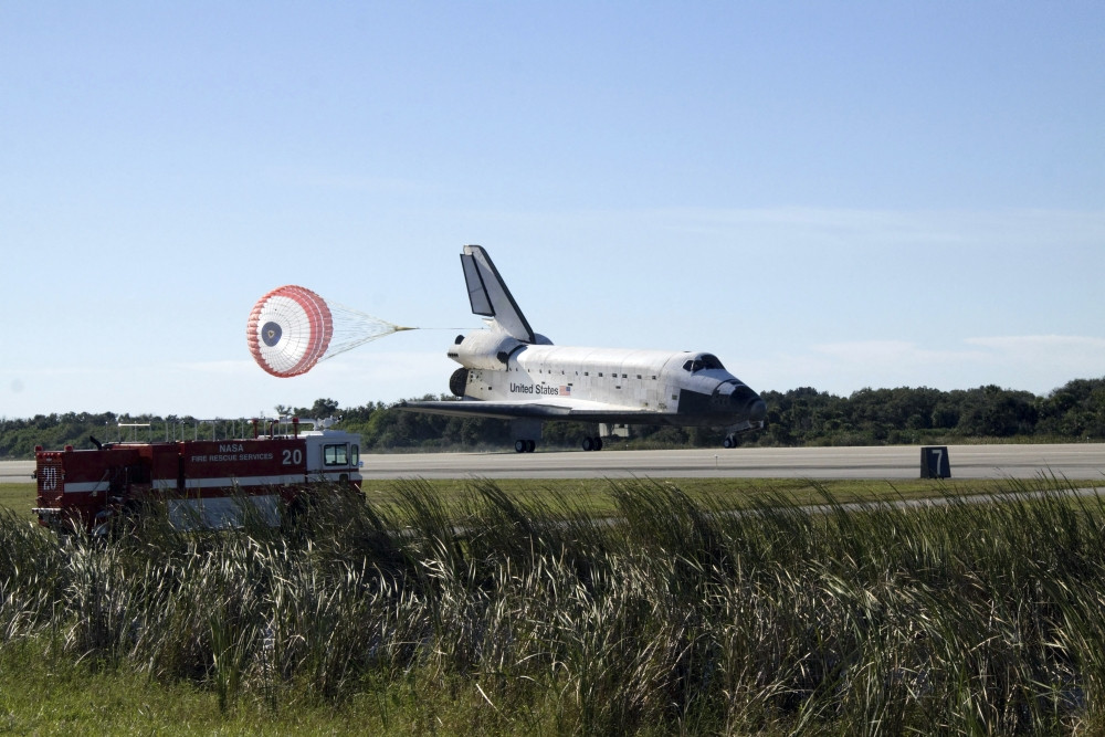 Space shuttle Atlantis unfurls its drag chute upon landing at Kennedy ...