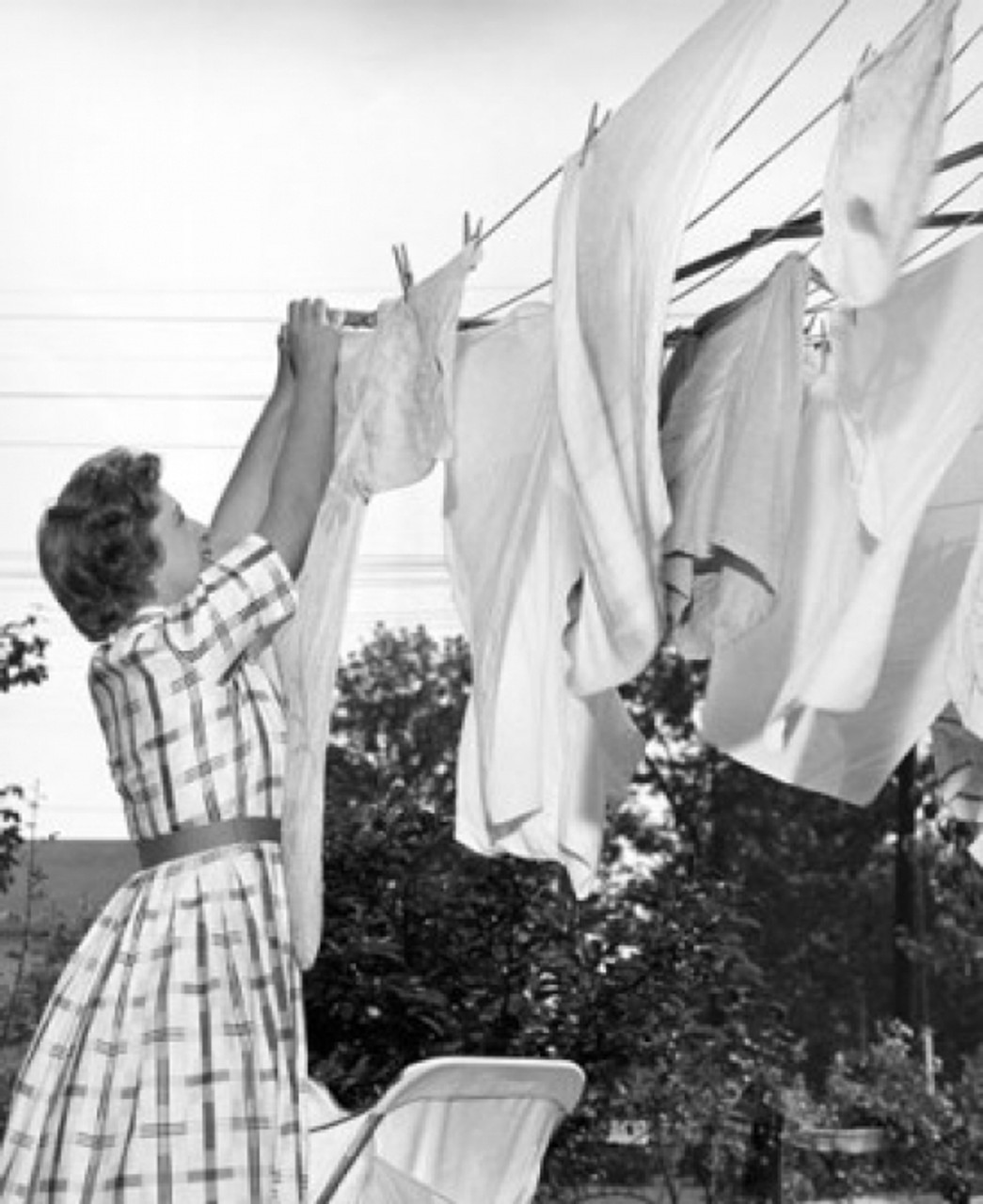 Young woman hanging clothes on a clothesline Poster Print - Item #  VARSAL25529026 - Posterazzi
