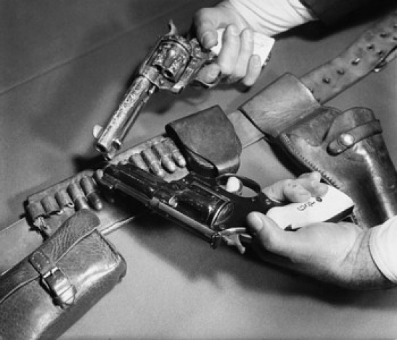 Close-up of man's hands holding a .45 Caliber Colt Army Revolver with a ...