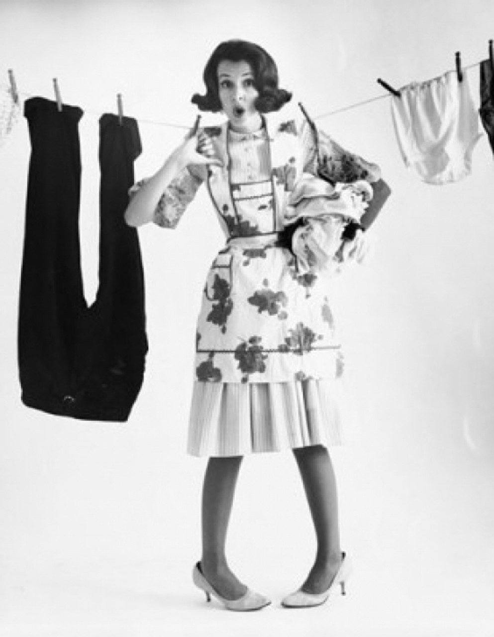 Young woman hanging clothes on a clothesline Poster Print - Item