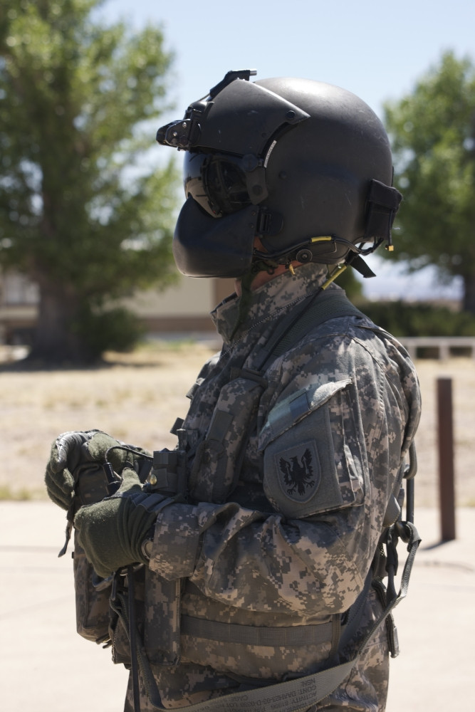 UH-60 Black Hawk crew chief stands outside his aircraft in