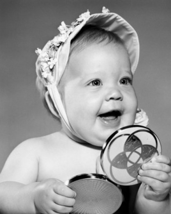 Portrait of baby girl holding hand mirror Poster Print Item