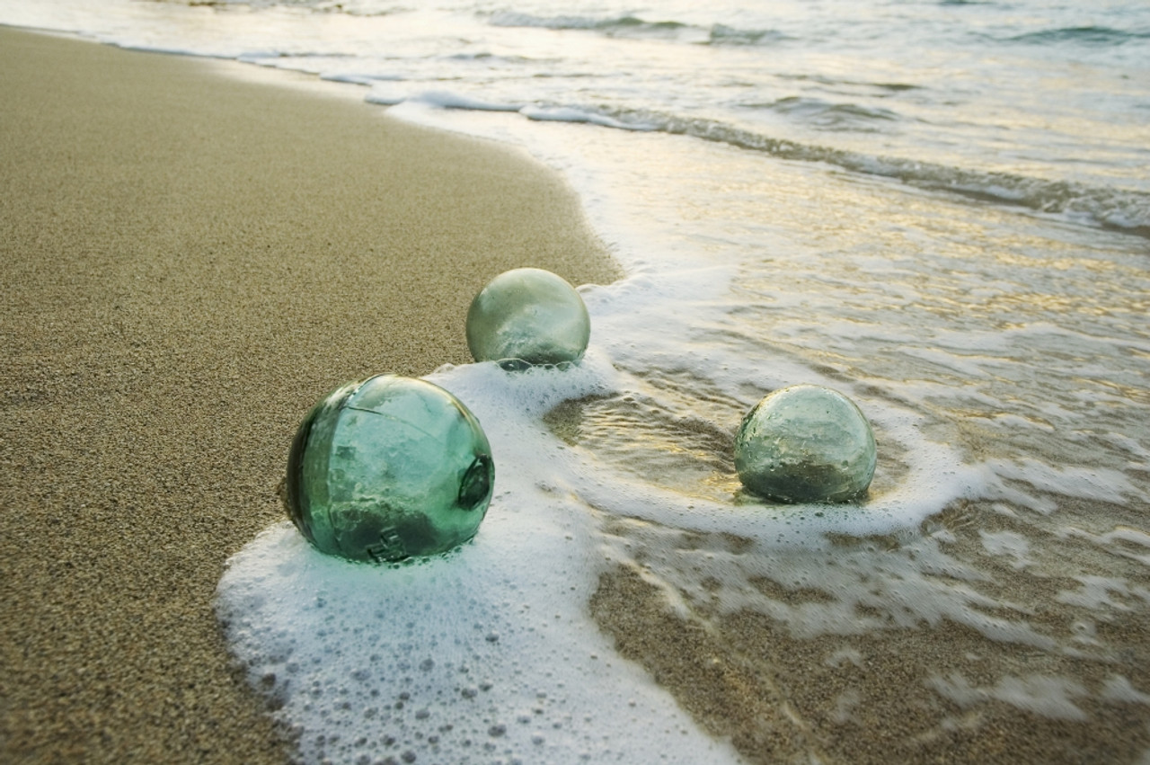 Three Glass Fishing Floats Roll On The Sandy Shoreline With Ripples Of Water  And Seafoam PosterPrint - Item # VARDPI1988045 - Posterazzi