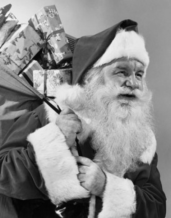Close-up of Santa Claus carrying a sack of Christmas presents on