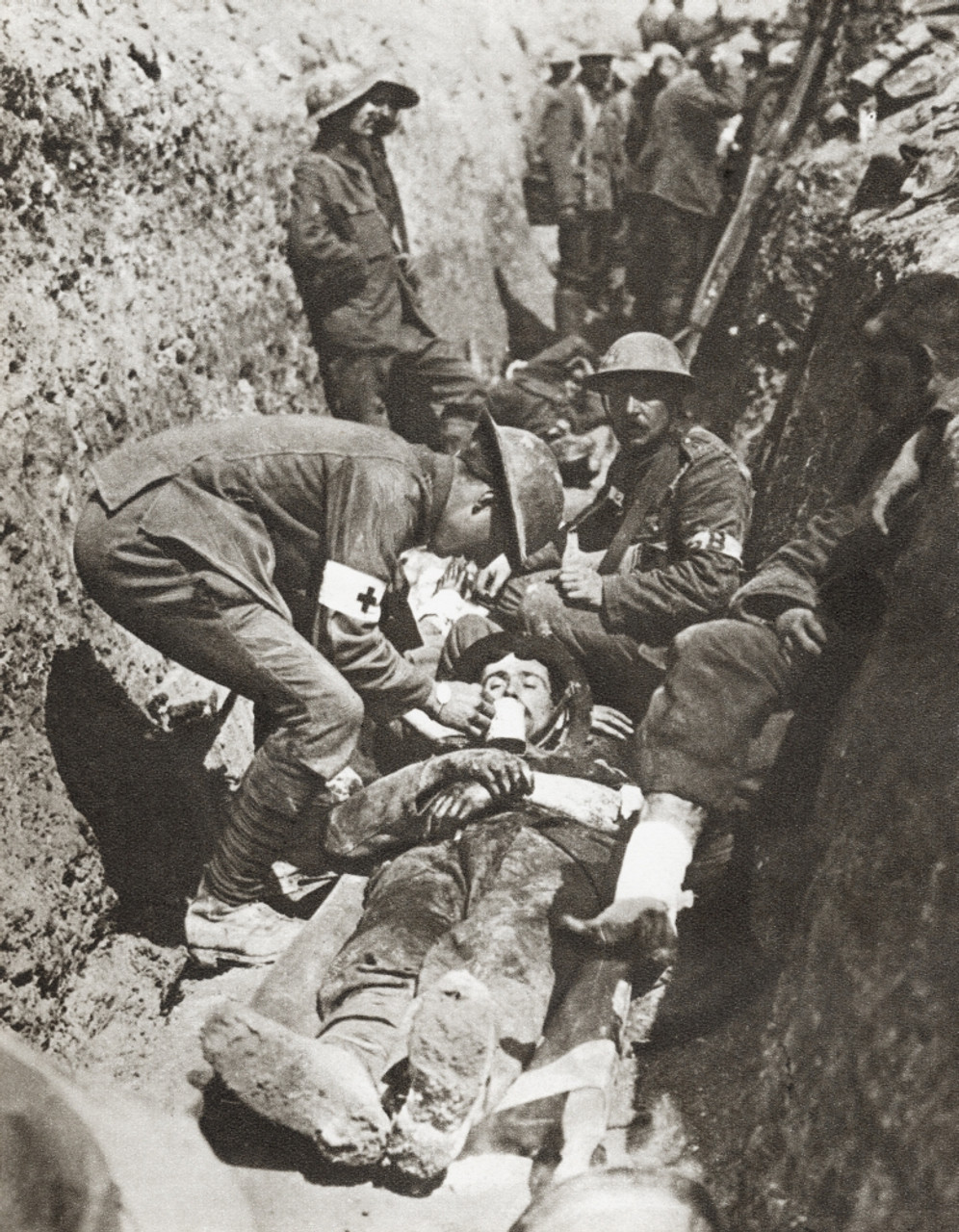 Stretcher Bearers Giving Aid To A Soldier Lying Wounded In A Trench On ...