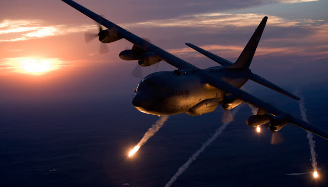 A C-130 Hercules releases flares during a mission over Kansas