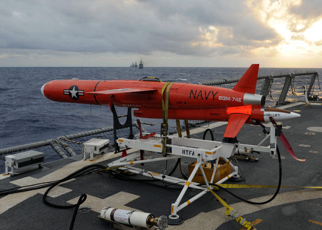 A BQM-74E drone prepares to launch from the flight deck of USS